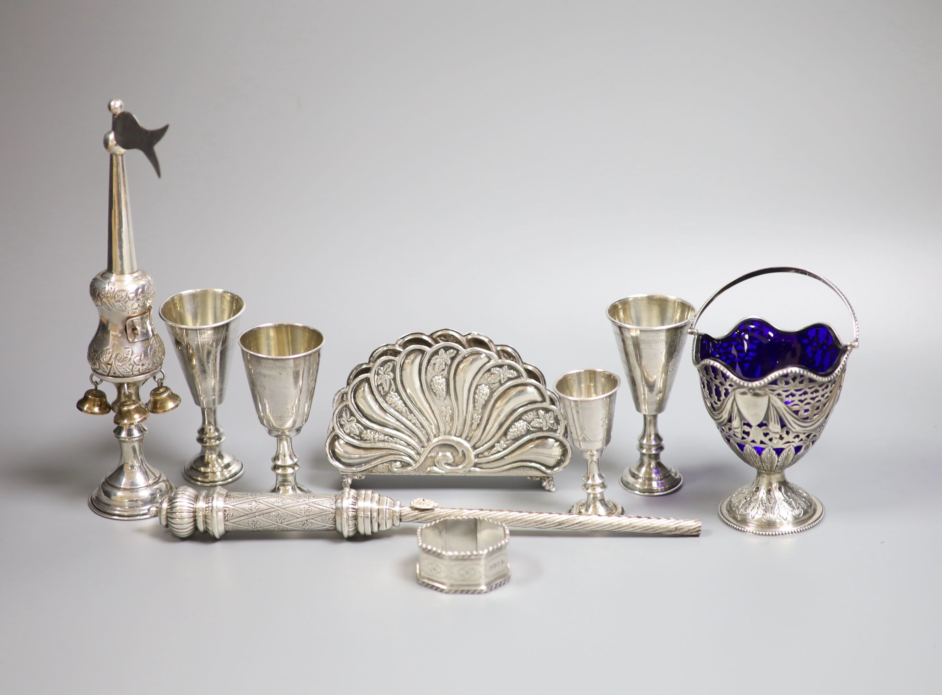 Four George V silver kiddush cups, largest 10.9cm, two other Judaic items, a 925 letter rack, silver napkin ring and Edwardian silver sugar basket.